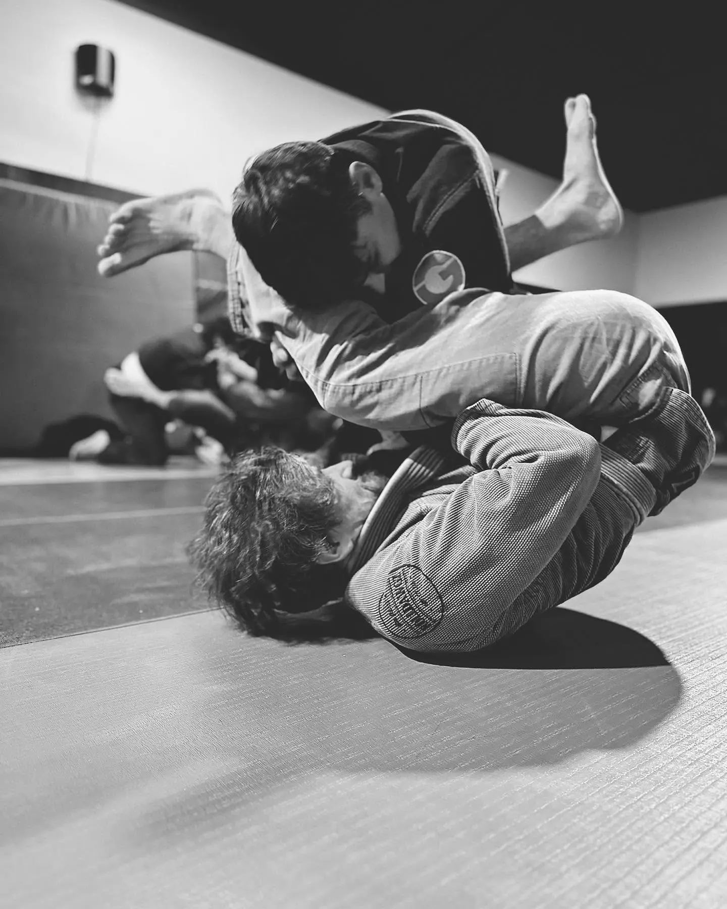 Two adults rolling Brazilian Jiu-Jitsu on the mat at 805 Combat Sports in Simi Valley