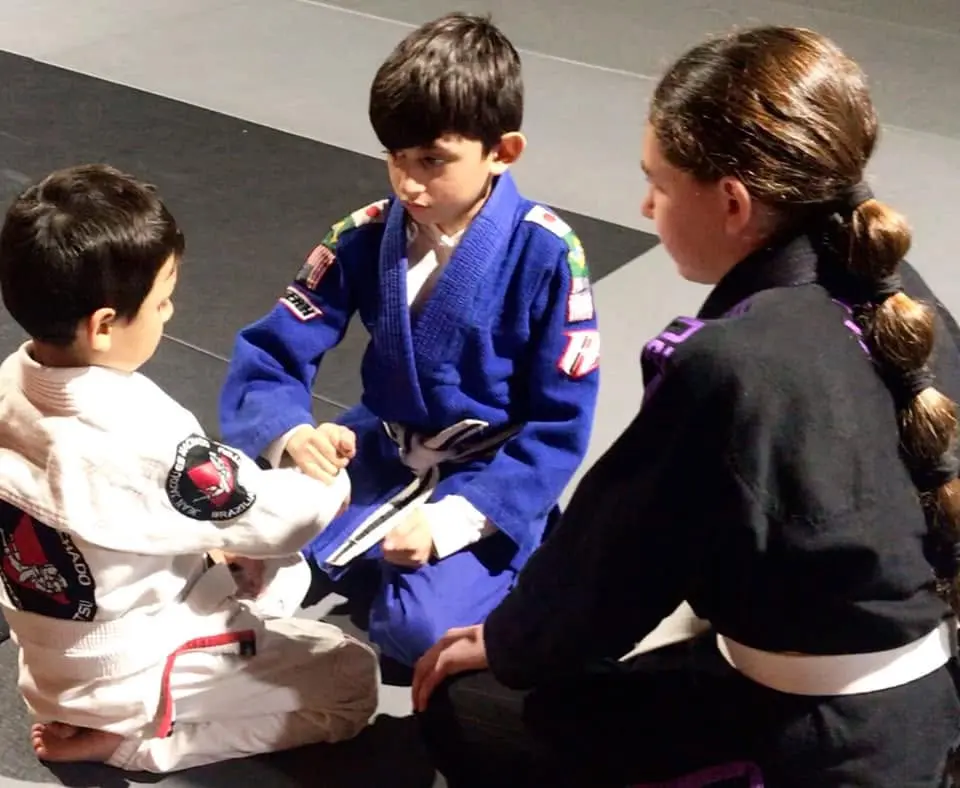 Young students fist-bumping before a drill at 805 Combat Sports in Simi Valley