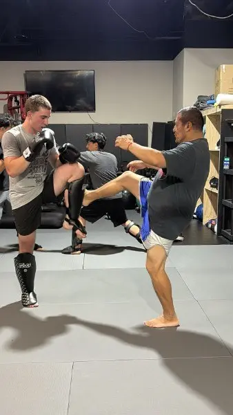 A student throwing a high kick during Muay Thai training at 805 Combat Sports in Simi Valley