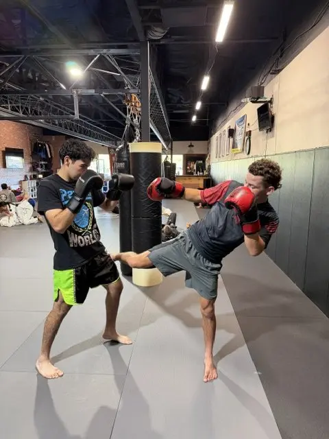 A student landing a high kick while sparring Muay Thai at 805 Combat Sports in Simi Valley