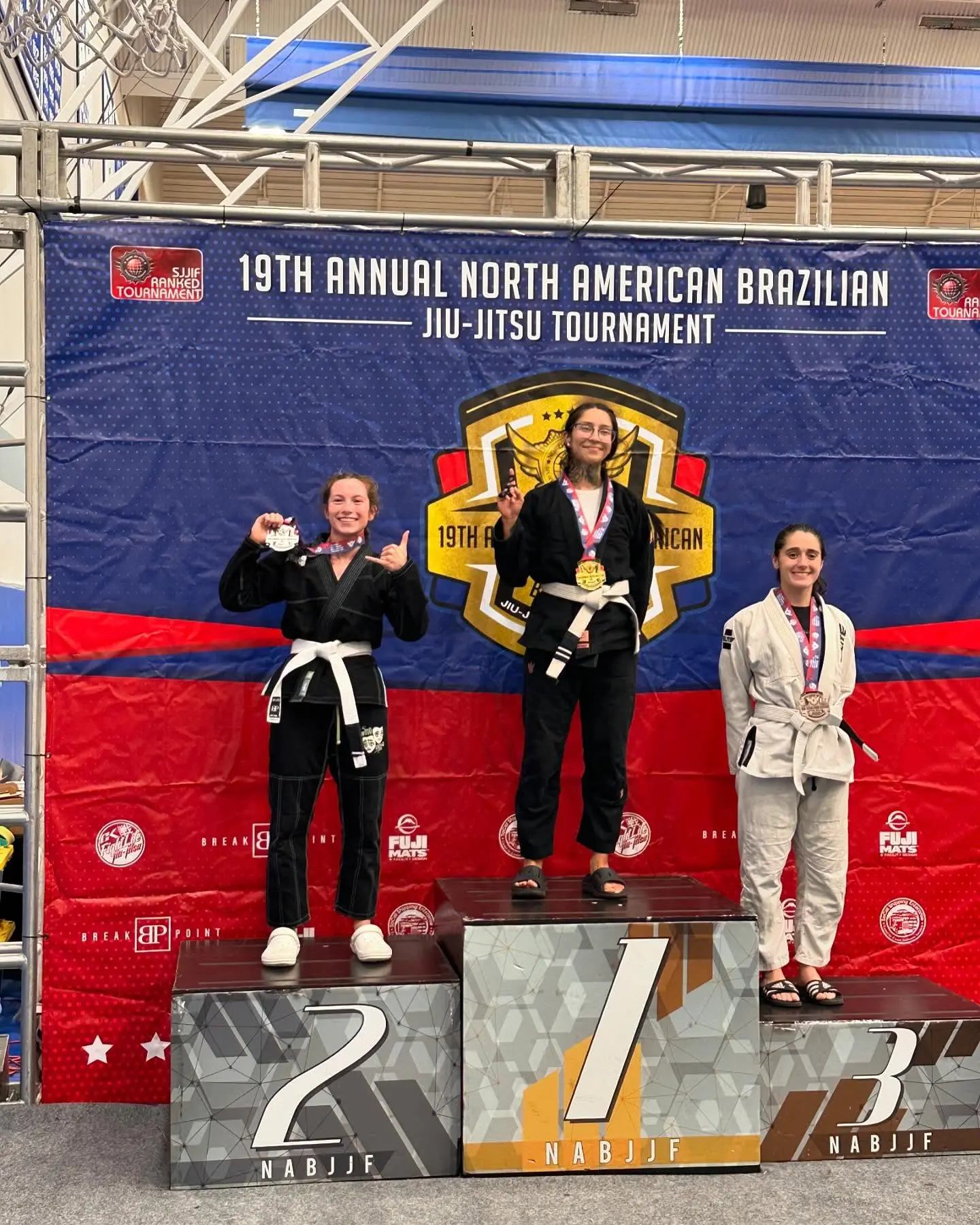 Women from 805 Combat Sports on the podium after a Brazilian Jiu-Jitsu competition
