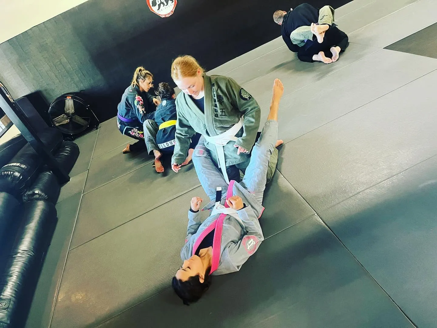 A woman drilling a self-defense technique at 805 Combat Sports in Simi Valley
